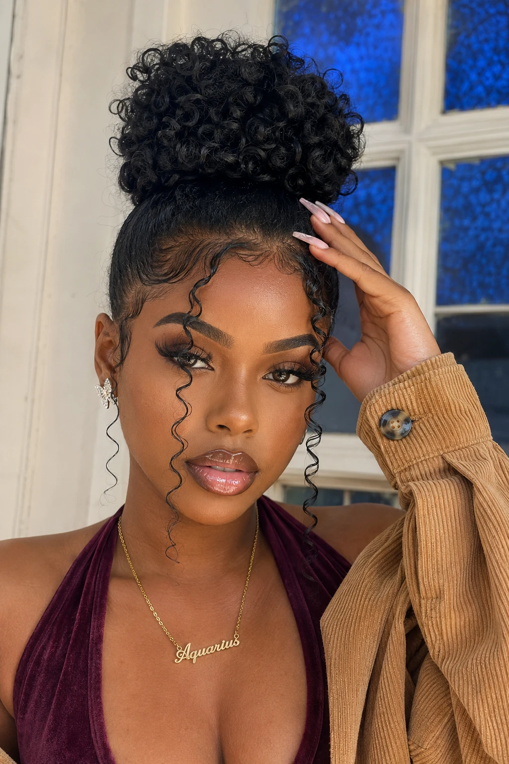  High Curly Bun with Wispy Face-Framing Tendrils