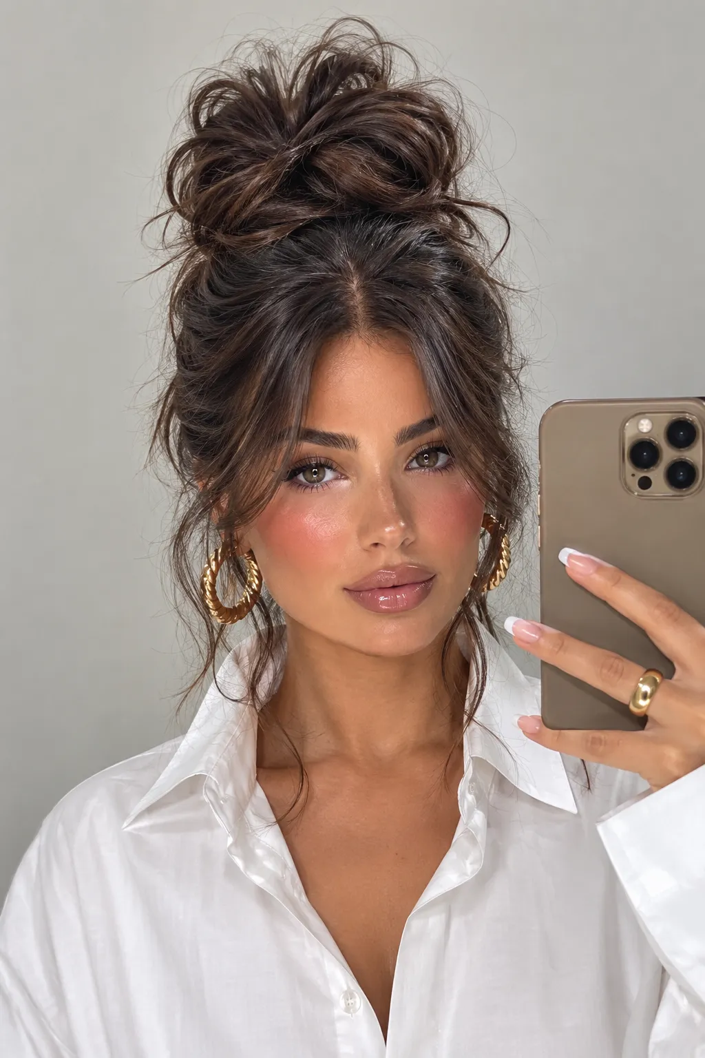 Messy High Bun with Face Framing Strands